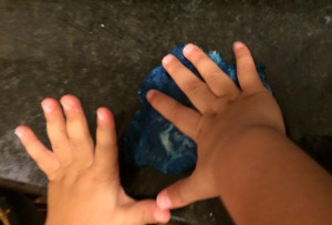 mixing dye into play dough