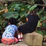 friends sitting among the lily pads