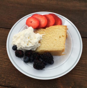 Pound cake served with fruit and whip cream